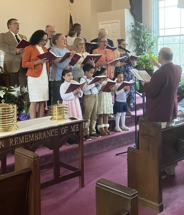 Pastor Joe directing the Still Water Christian Fellowship choir